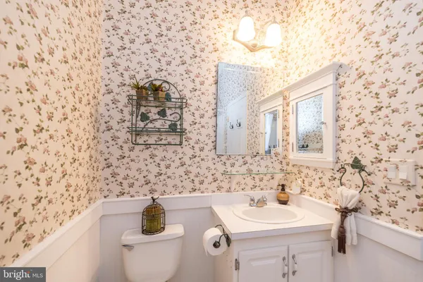 a bathroom with a sink a toilet and mirror