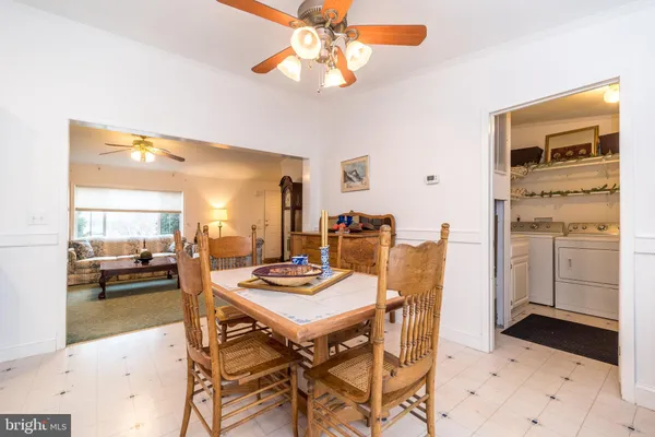 a dining room with furniture a rug and a chandelier