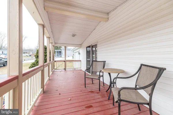 a view of a room with furniture wooden floor and windows