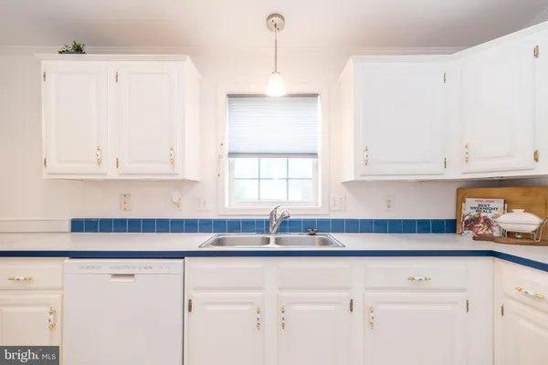 a kitchen with white cabinets and a sink