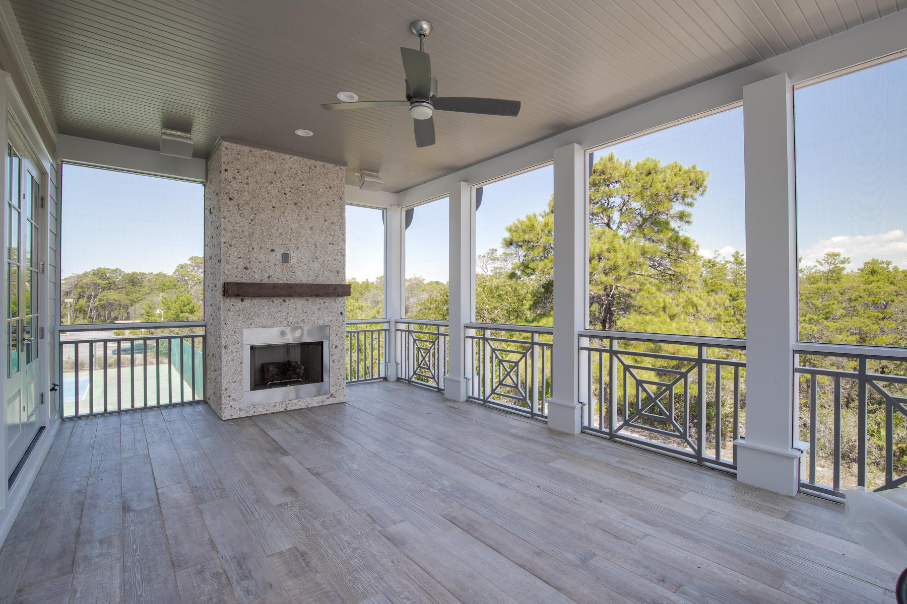 446 Morgans Trail Santa Rosa Beach, FL 32459 - Photo 36 of 49 a view of an empty room with wooden floor a fireplace and a window