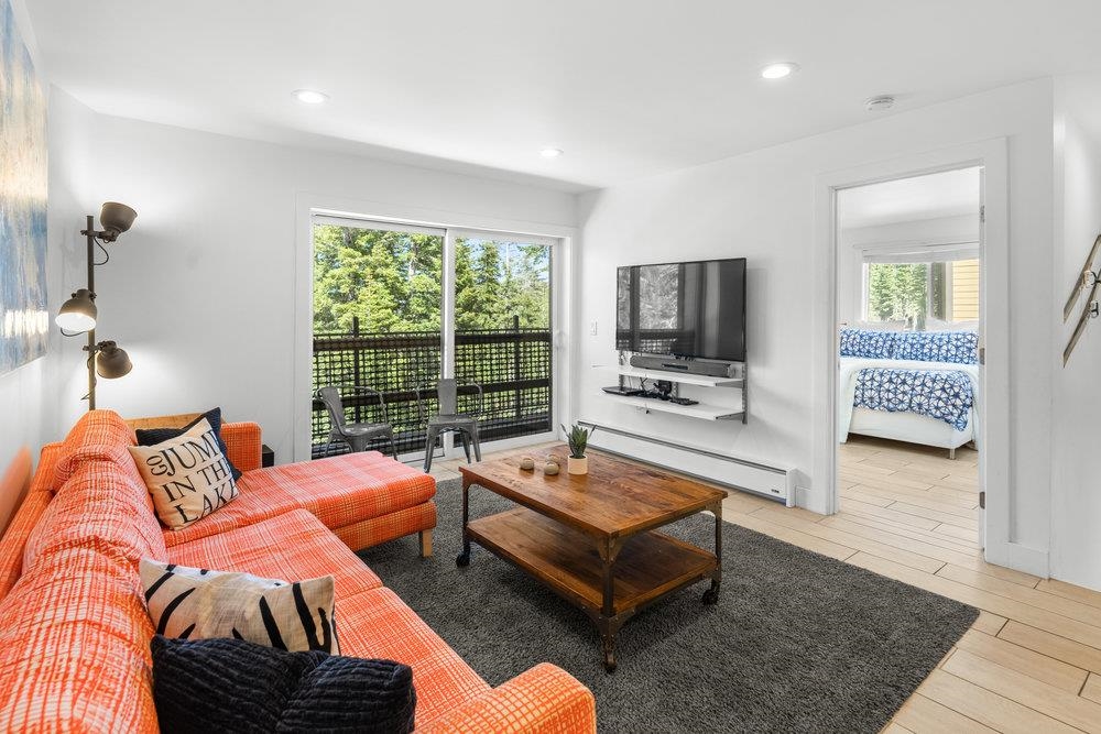 2090 Chalet Road, Unit 4 Alpine Meadows, CA 96146 - Photo 12 of 28 a living room with furniture and a flat screen tv