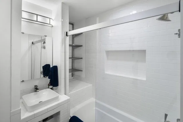 a bathroom with a sink toilet and shower