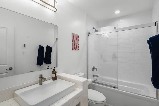 a bedroom with furniture and a rug