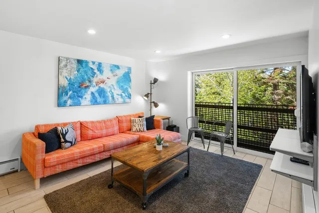 a view of a balcony with wooden floor and bench