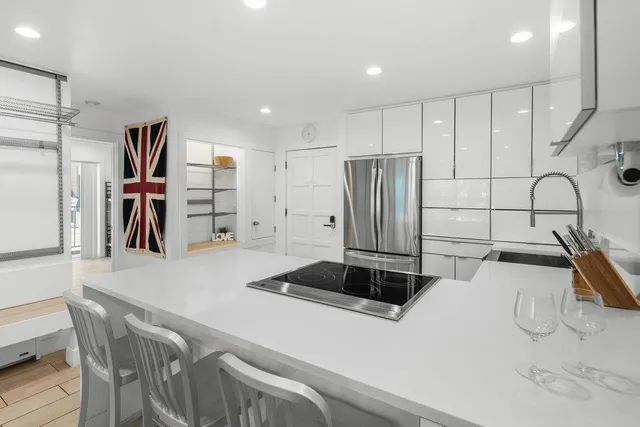 a kitchen with a sink appliances and cabinets