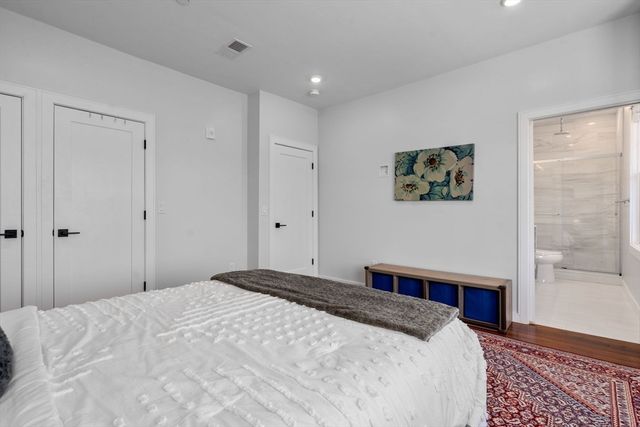 a bedroom with a large bed and a window