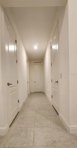an empty room with fan and entrance