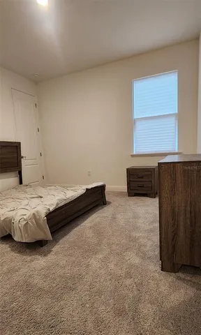 a bedroom with a bed and cabinets