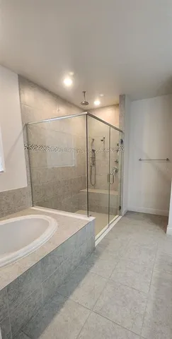 a view of a bathroom with a tub and shower