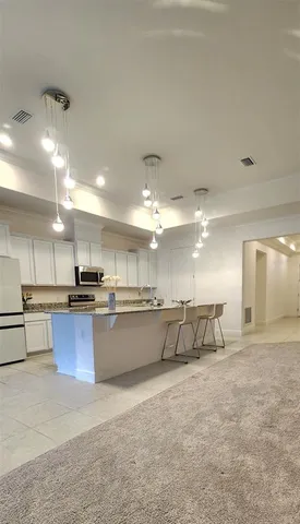 a large kitchen with lots of counter space and a sink