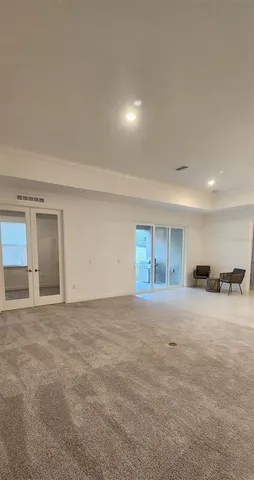 a view of an empty room with a window and fireplace