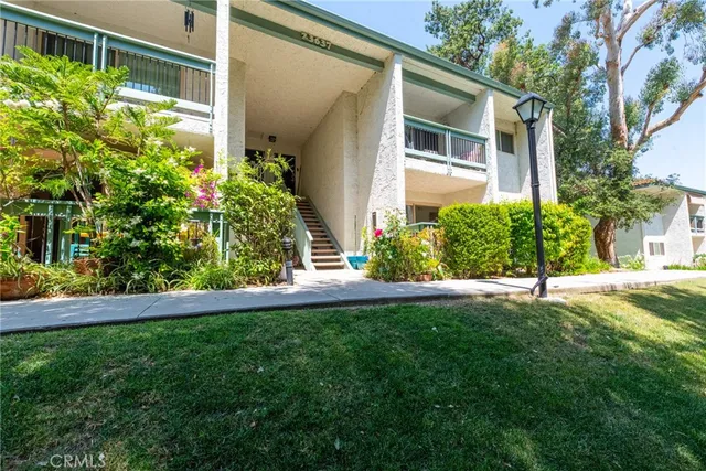 a view of a house with a yard and plants