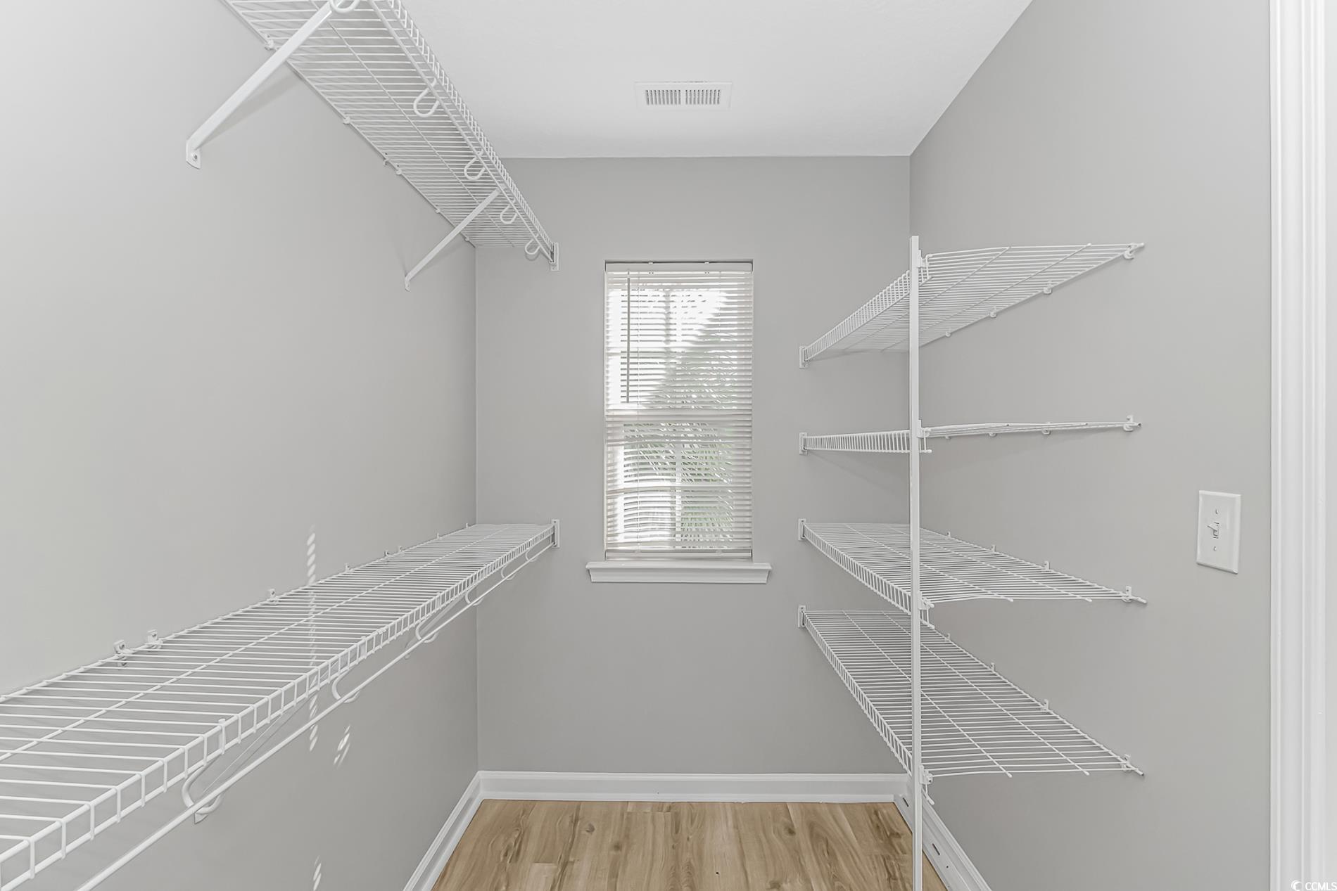 502 Lake Shore Drive Surfside Beach, SC 29575 - Photo 11 of 25 Walk in closet with light wood-type flooring