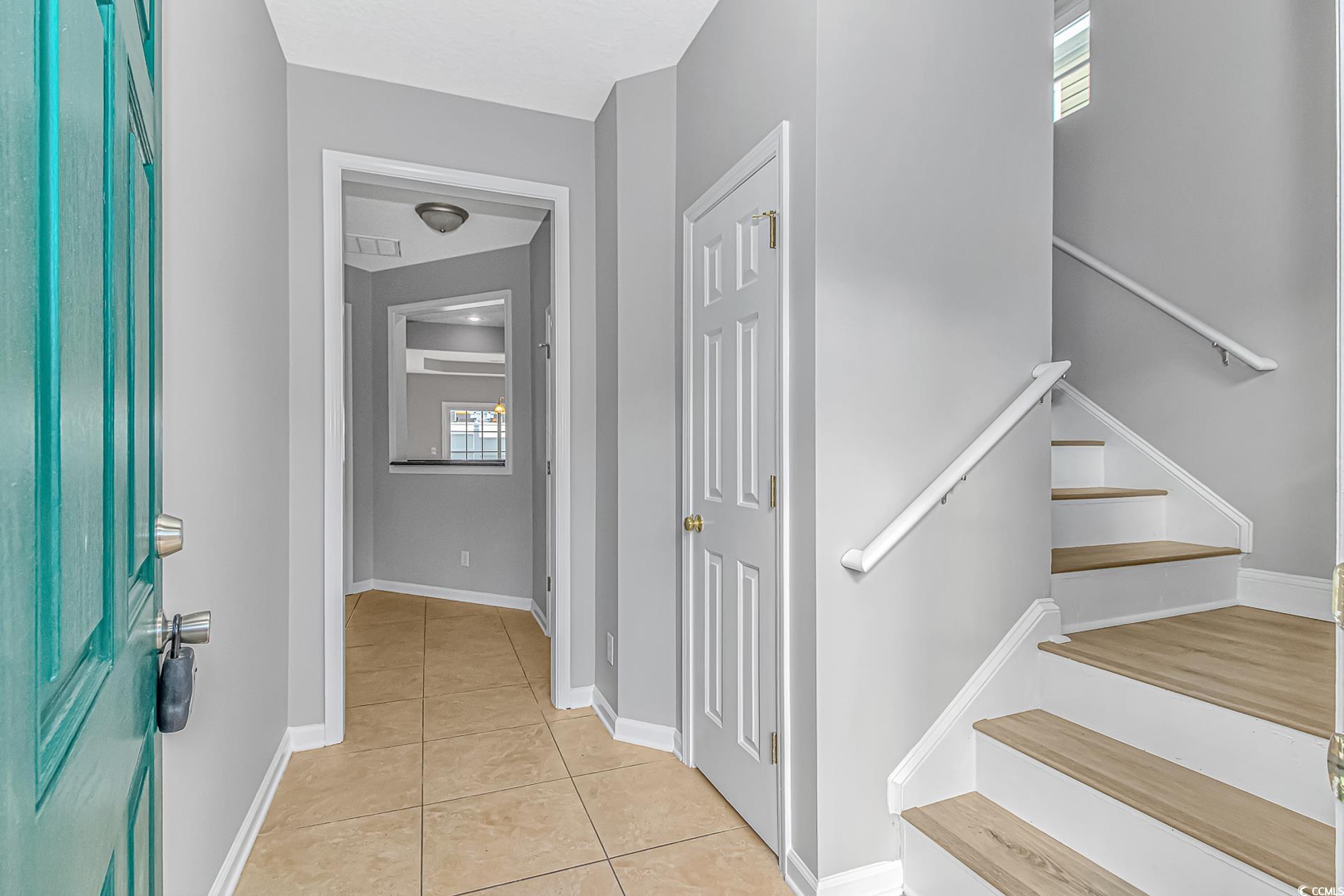502 Lake Shore Drive Surfside Beach, SC 29575 - Photo 2 of 25 Foyer entrance featuring stairs and light tile patterned floors