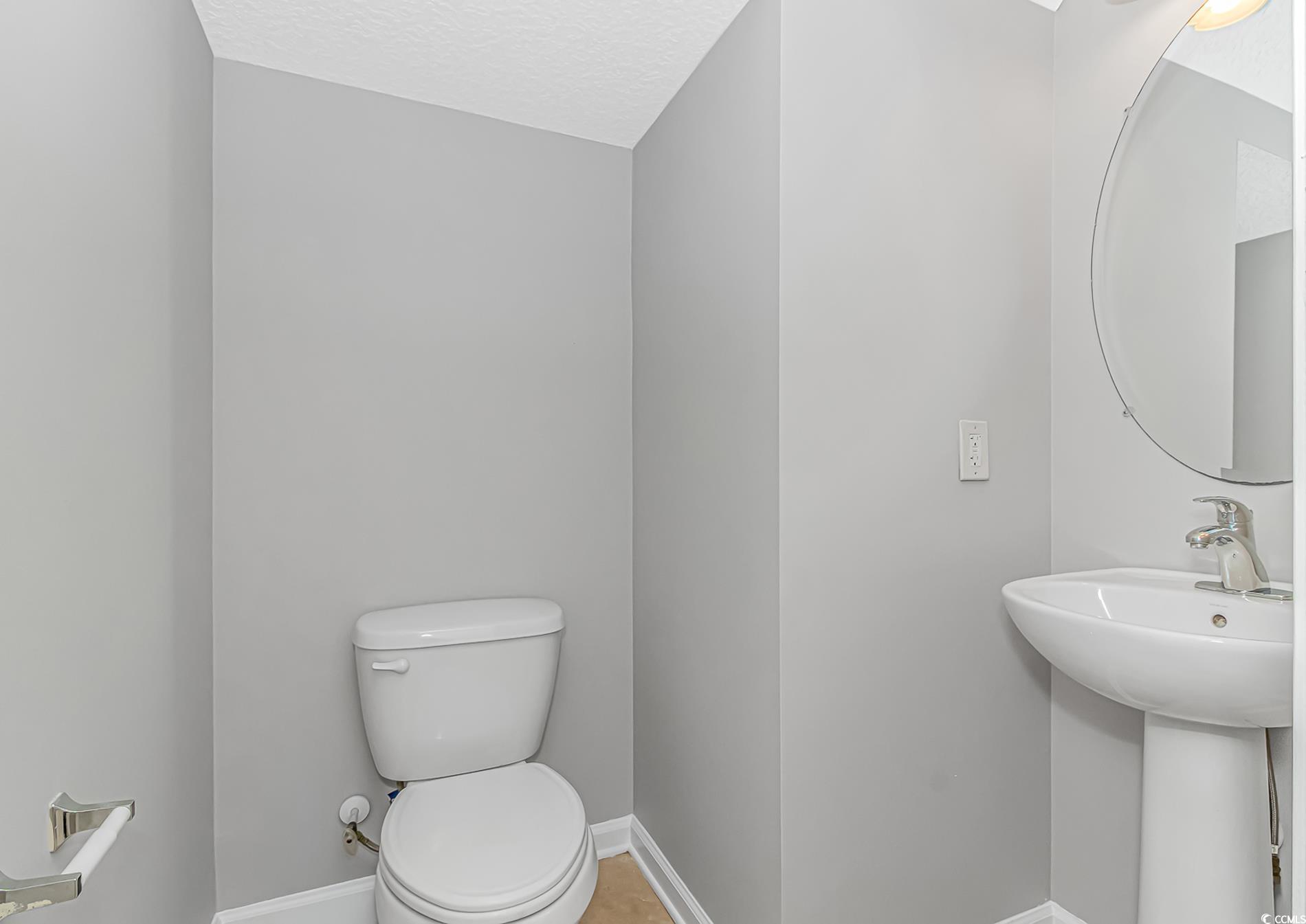 502 Lake Shore Drive Surfside Beach, SC 29575 - Photo 8 of 25 Half bathroom featuring baseboards and a textured ceiling