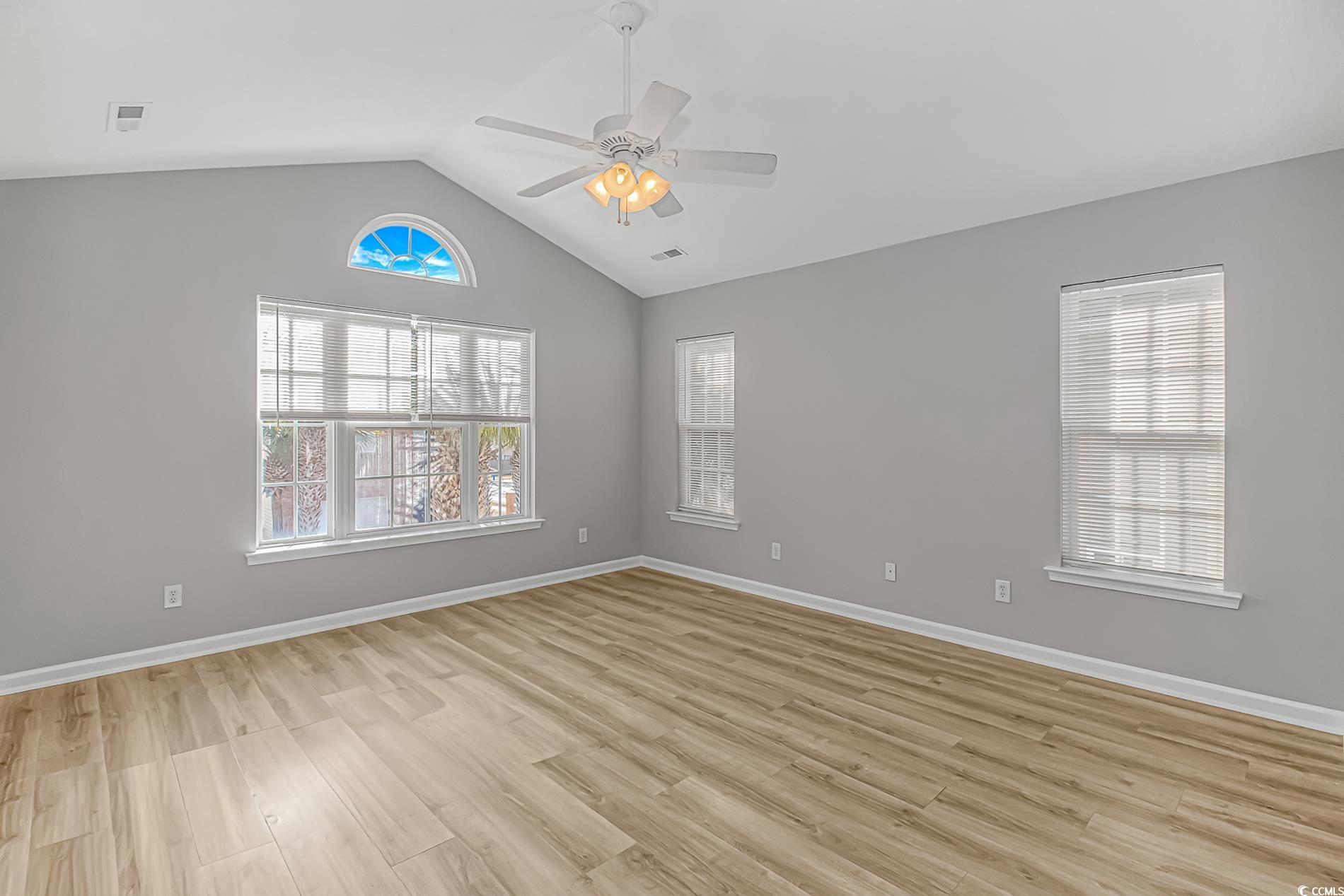 502 Lake Shore Drive Surfside Beach, SC 29575 - Photo 9 of 25 Spare room featuring light wood-type flooring, lofted ceiling, and ceiling fan