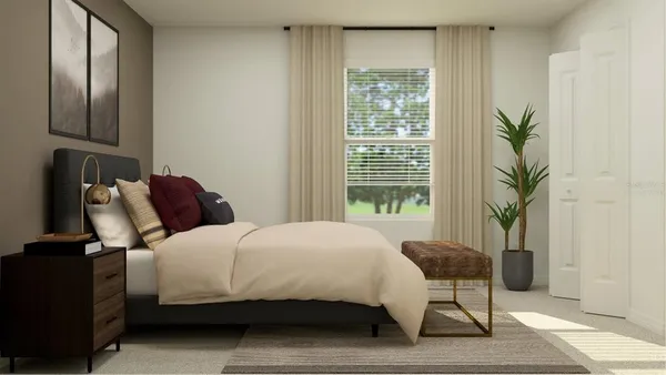 a bedroom with a bed and a potted plant