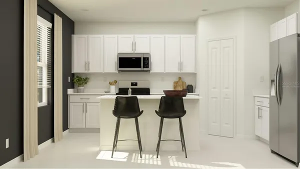 a kitchen with stainless steel appliances a refrigerator a stove a microwave and furniture