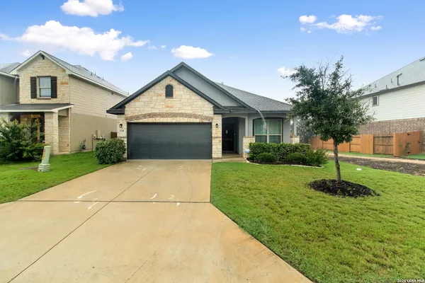 a front view of house with yard and green space
