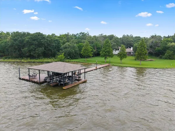 a living room with furniture a piano and a floor to ceiling window