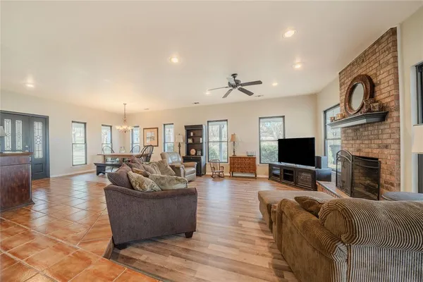 a living room with stainless steel appliances kitchen island granite countertop furniture and a kitchen view