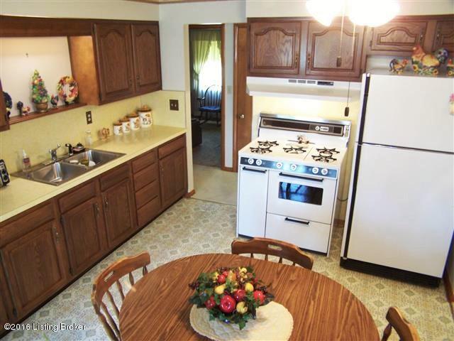 10907 Deering Road Louisville, KY 40272 - Photo 16 of 38 Eat-In Kitchen with full complement of kitchen appliances, lots of cabinet space, walk-in double door pantry, access to the rear deck, viewing window into the Sun Room, new ceiling fan/light fixture and has access to the hallway as well as the Dining Room and Sun Room.