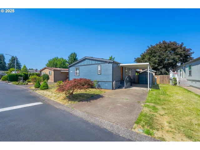 a view of a house with a yard and potted plants