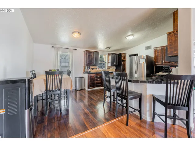 a dining room with furniture and wooden floor