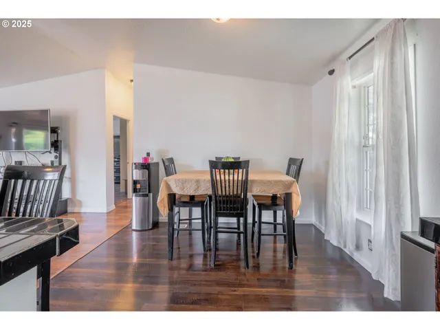 a dining room with furniture and wooden floor