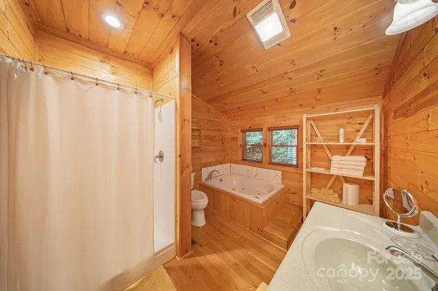 a bedroom with furniture and a flat screen tv