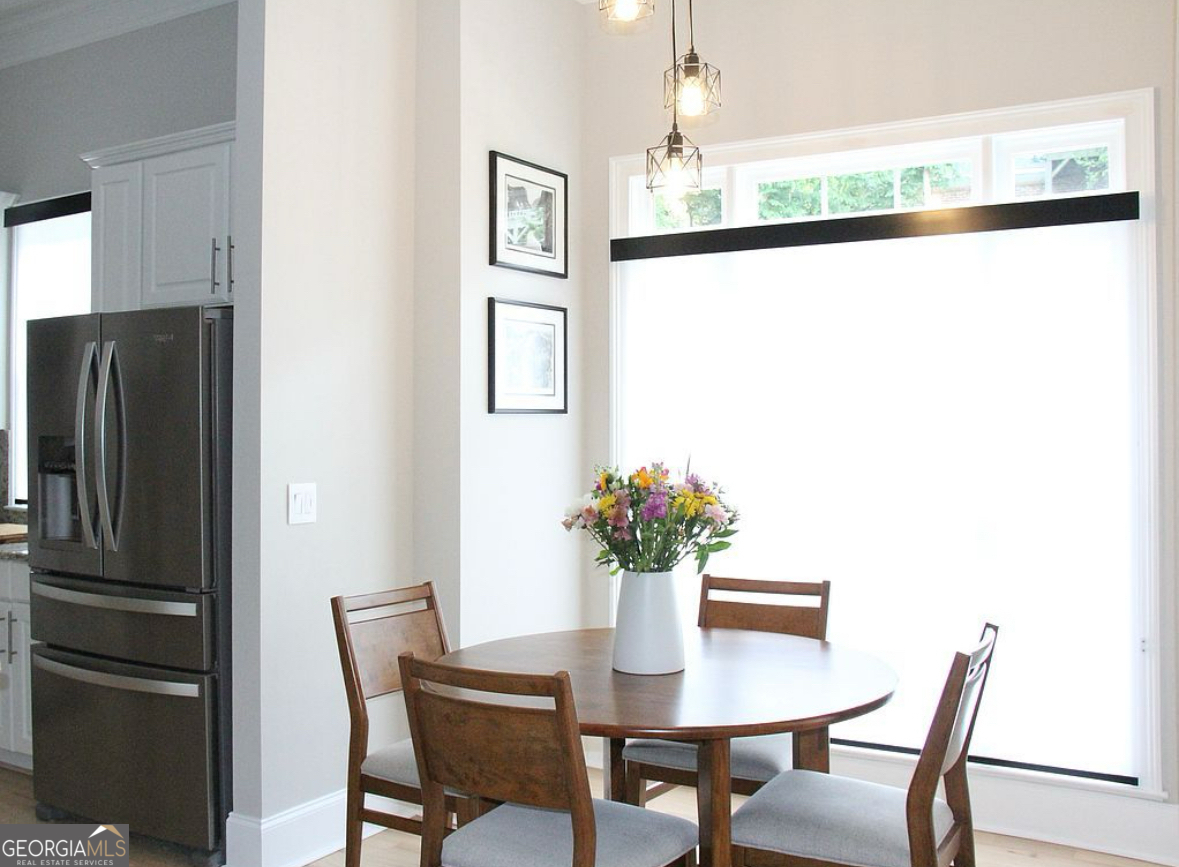 996 Pitts Road, Unit D Sandy Springs, GA 30350 - Photo 11 of 39 a dining room with furniture and window