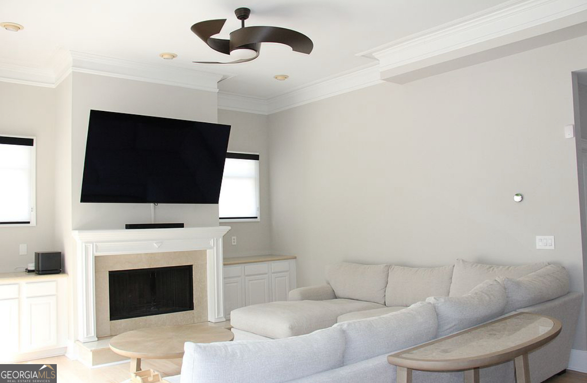 996 Pitts Road, Unit D Sandy Springs, GA 30350 - Photo 12 of 39 a living room with furniture a fireplace and a flat screen tv