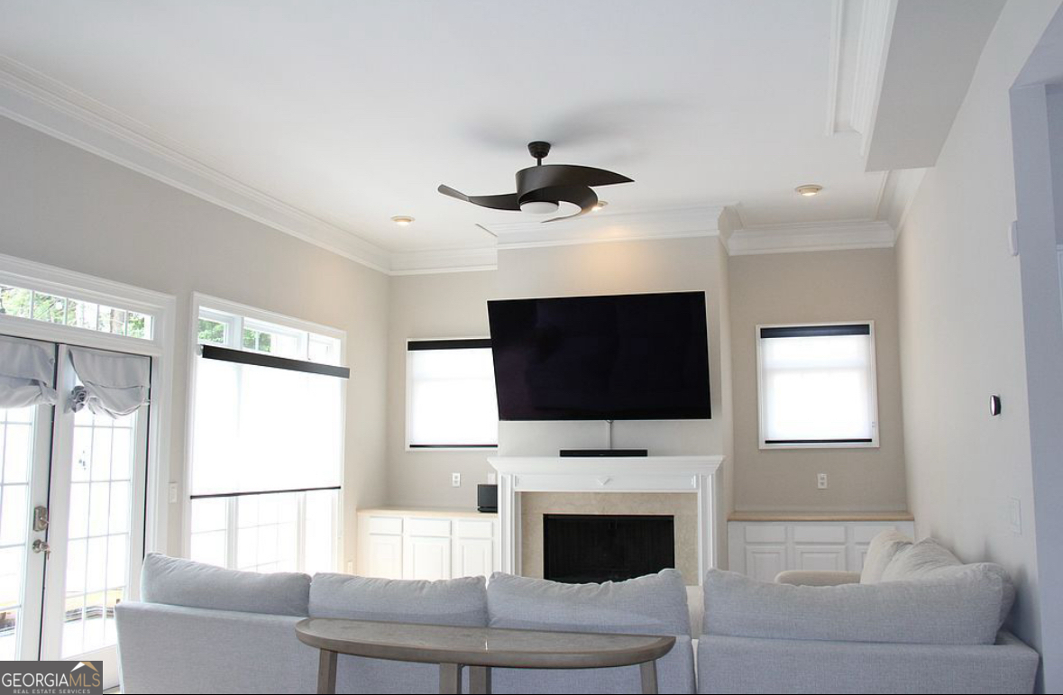996 Pitts Road, Unit D Sandy Springs, GA 30350 - Photo 13 of 39 a living room with furniture a flat screen tv and a fireplace