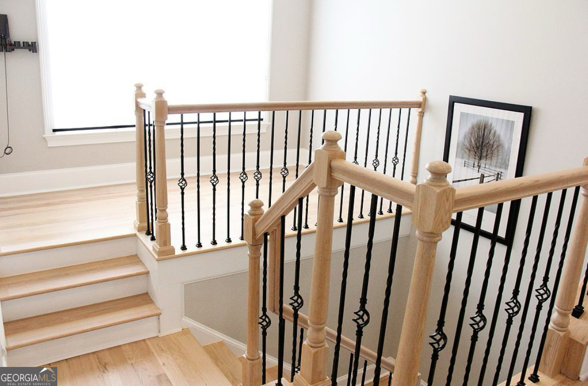 996 Pitts Road, Unit D Sandy Springs, GA 30350 - Photo 15 of 39 a view of staircase with lots of frames on wall and a window