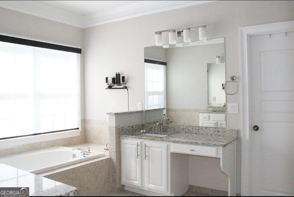 996 Pitts Road, Unit D Sandy Springs, GA 30350 - Photo 22 of 39 a bathroom with a granite countertop sink and a mirror