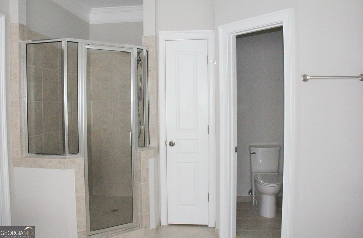 996 Pitts Road, Unit D Sandy Springs, GA 30350 - Photo 23 of 39 a bathroom with a glass shower door