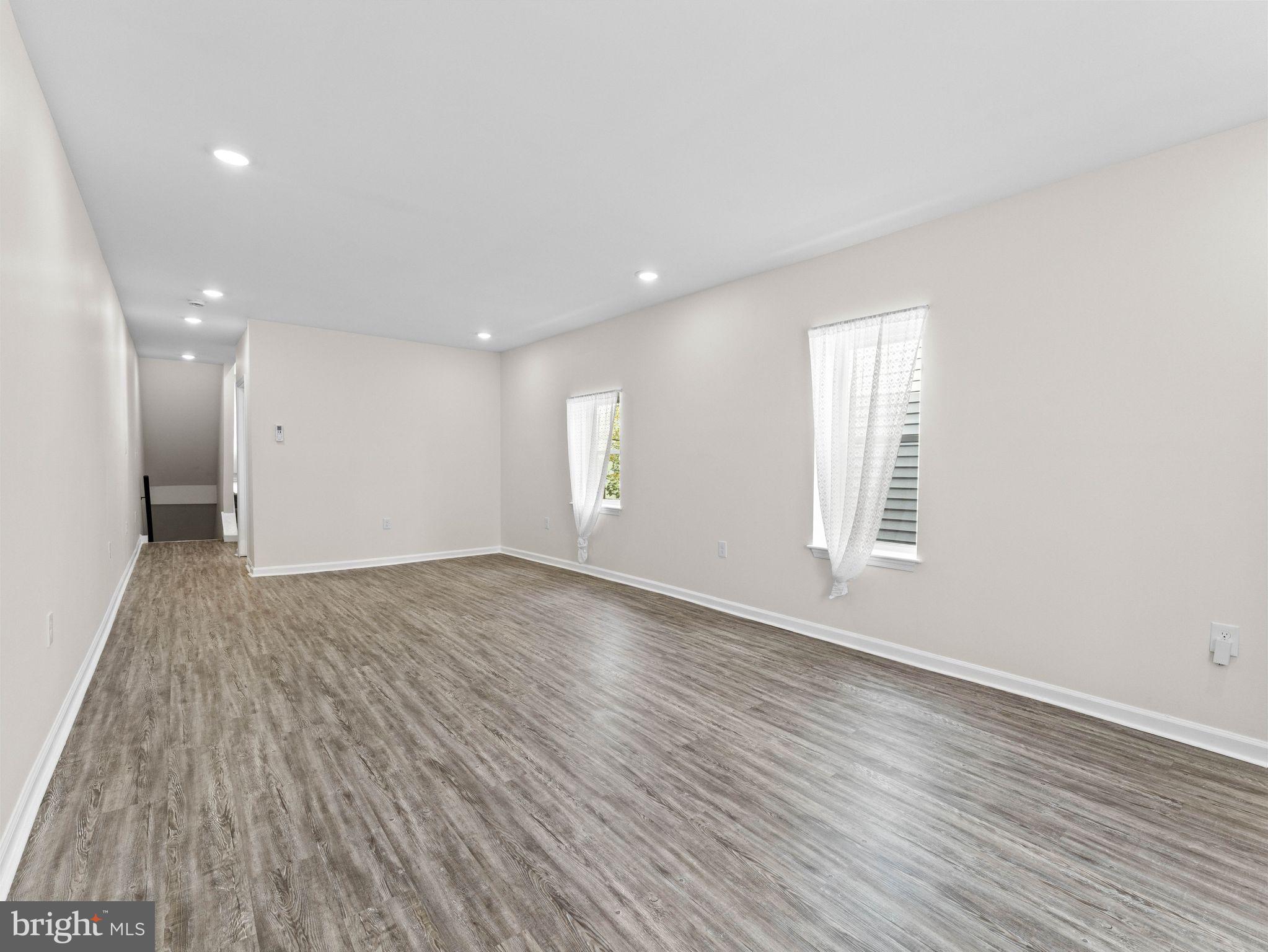 1923 North 20th Street, Unit 2 Philadelphia, PA 19121 - Photo 17 of 50 an empty room with wooden floor and windows