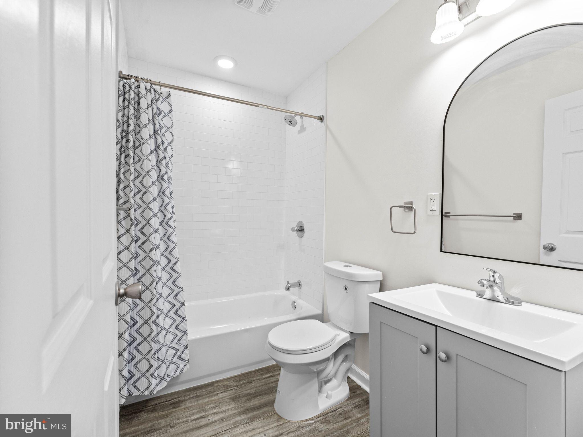 1923 North 20th Street, Unit 2 Philadelphia, PA 19121 - Photo 18 of 50 a bathroom with a toilet a sink and a bathtub