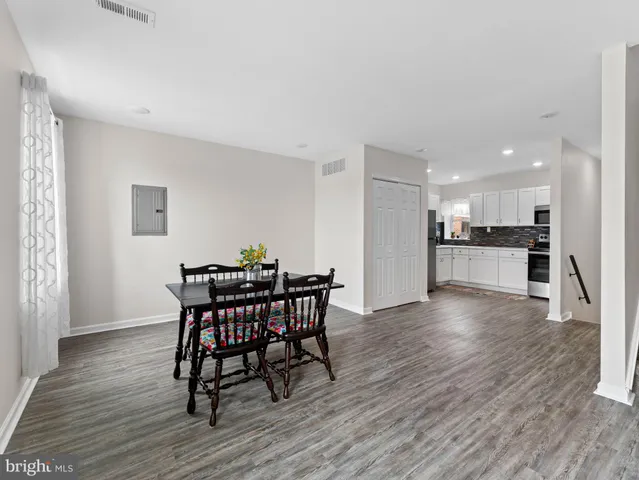 a kitchen with granite countertop white cabinets and stainless steel appliances