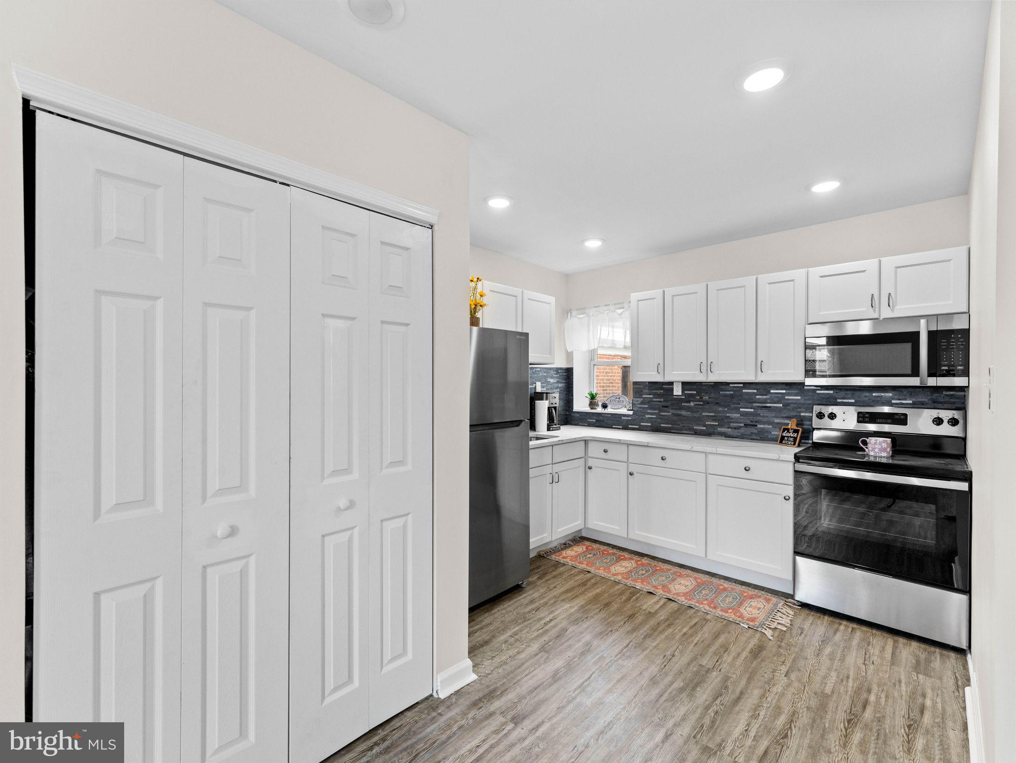 1923 North 20th Street, Unit 2 Philadelphia, PA 19121 - Photo 23 of 50 a kitchen with granite countertop white cabinets and stainless steel appliances