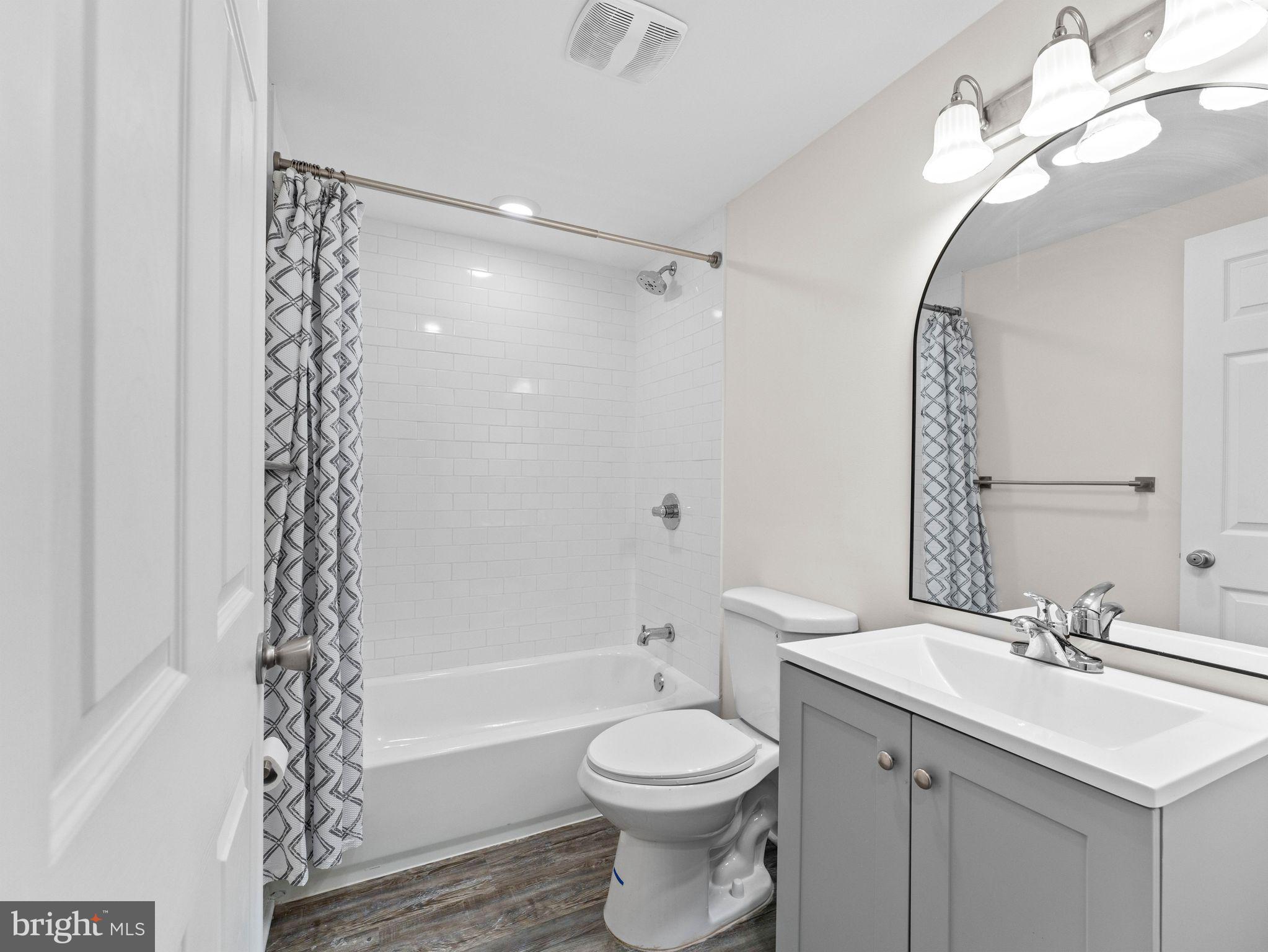 1923 North 20th Street, Unit 2 Philadelphia, PA 19121 - Photo 8 of 50 a bathroom with a sink a toilet and shower