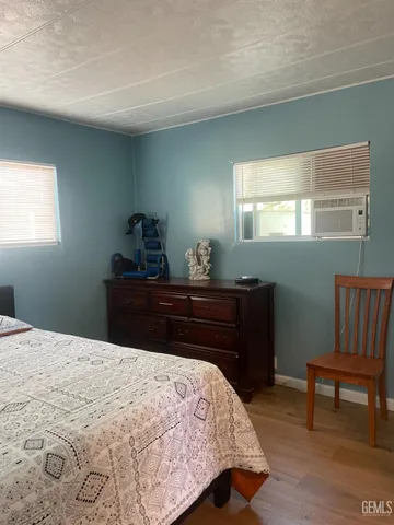 a bed sitting in a bedroom next to a window