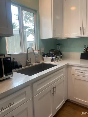 a kitchen with appliances cabinets and a sink