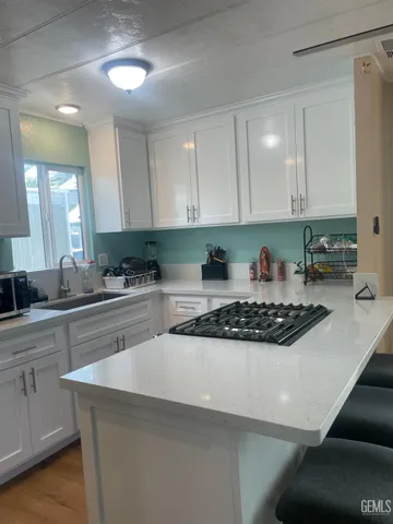 a kitchen with stainless steel appliances granite countertop a sink a stove and a refrigerator