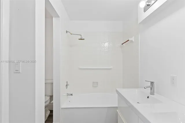 a white bath tub sitting next to a white sink