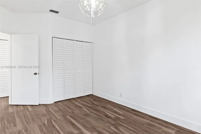 an empty room with wooden floor