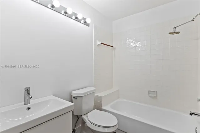 a white toilet sitting next to a bath tub