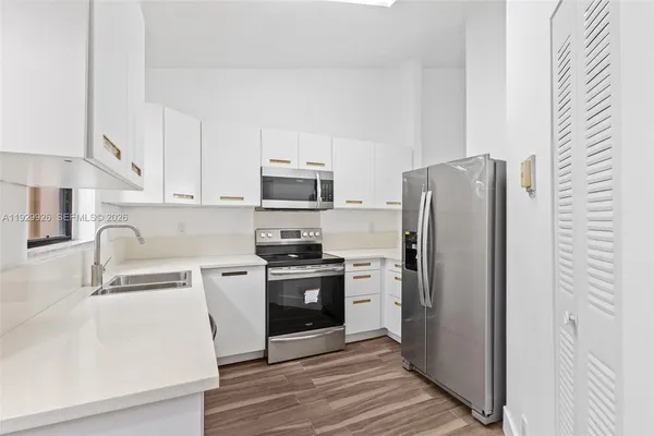 a kitchen with stainless steel appliances a refrigerator stove and sink
