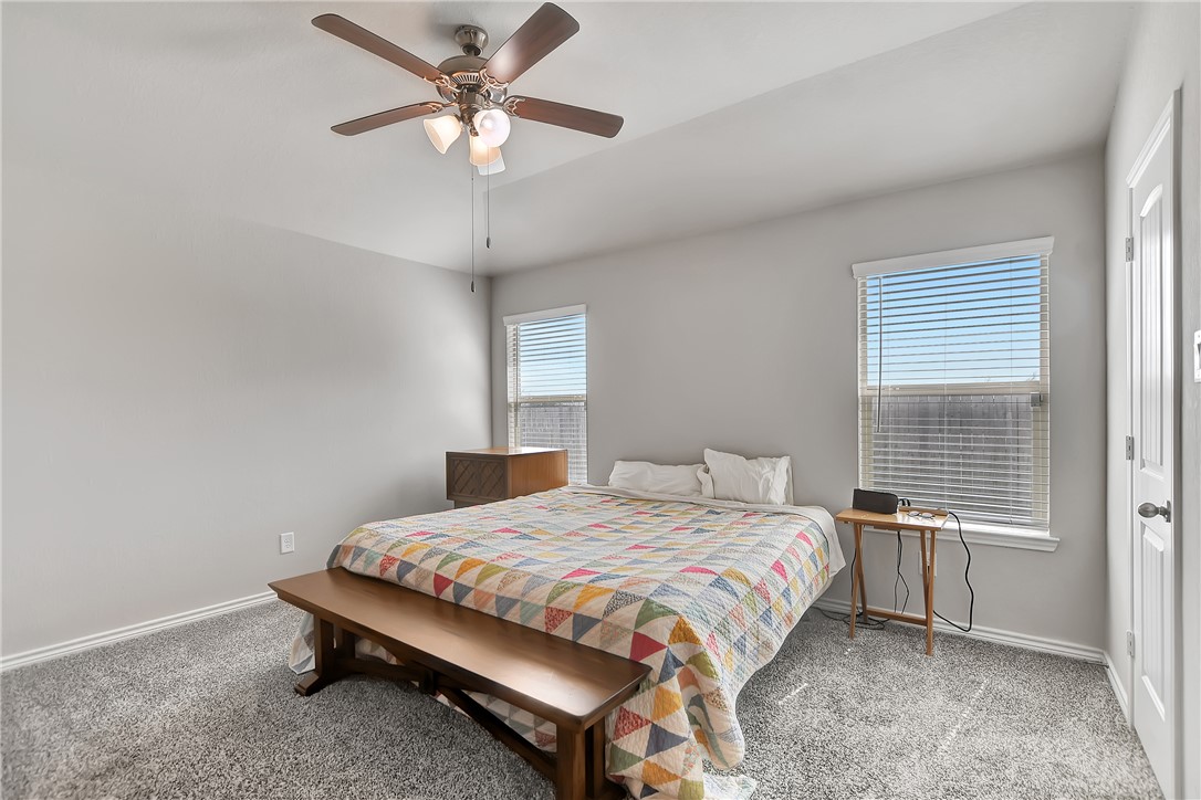 909 Davy Street Brenham, TX 77833 - Photo 16 of 35 Carpeted bedroom featuring a ceiling fan and vaulted ceiling